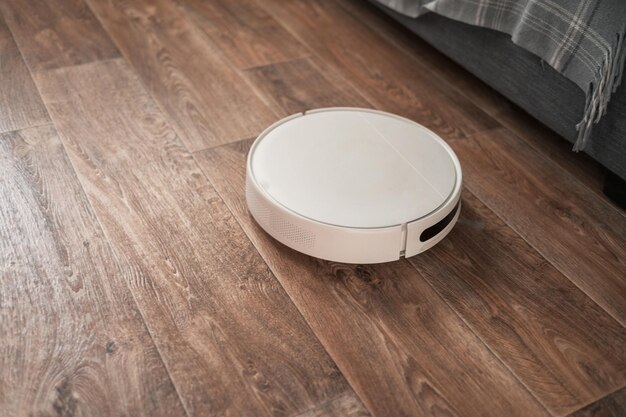 Robot vacuum cleaner performs automatic cleaning of the apartment smart home concept