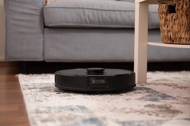 Robot vacuum cleaner tidyin the carpet in living room