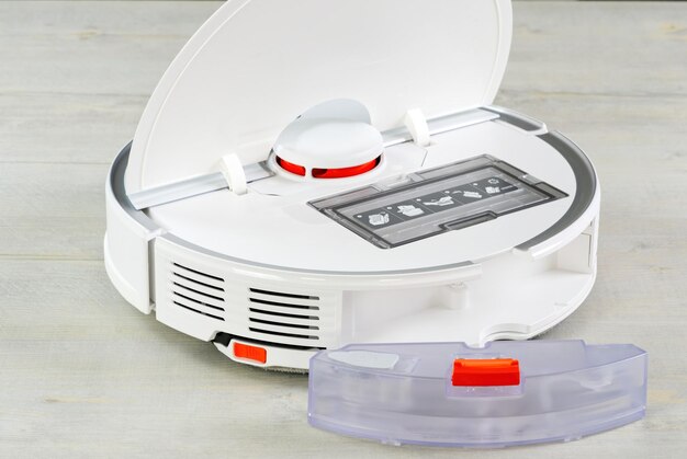 Robot vacuum cleaner water tank removed and the filter lid is opened to clean Smart cleaning and washing technology advanced robot