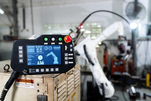 Robotic arm and its controller adept panel in a factory workshop