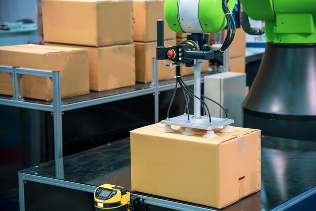 Robotic hands simultaneous work at packaging line.