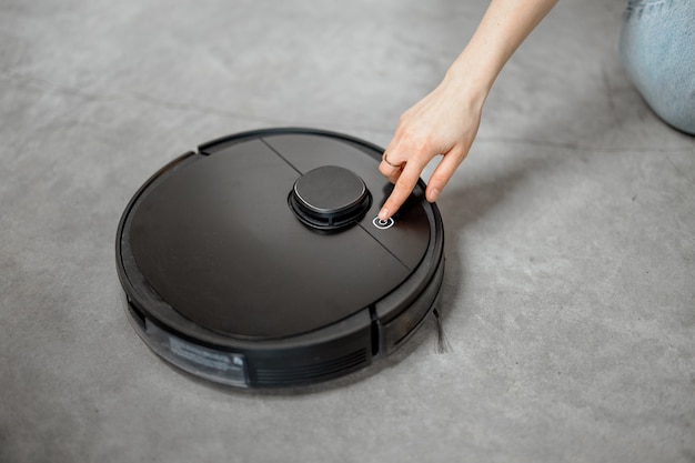 Robotic vacuum cleaner cleaning the room at home