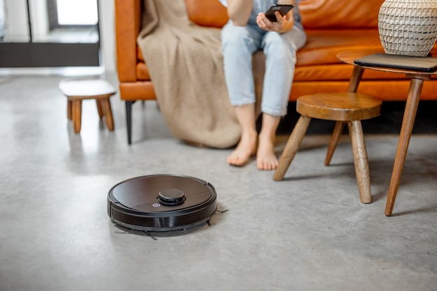 Robotic vacuum cleaner cleaning the room at home