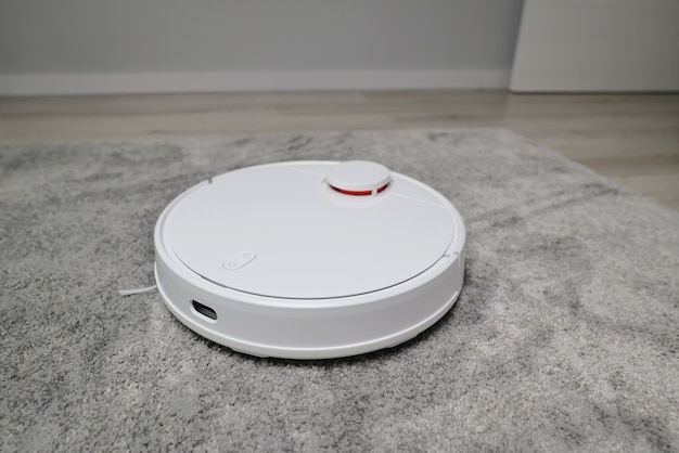 Robotic vacuum cleaner working on carpet top view concept Smart electronic housekeeping technology