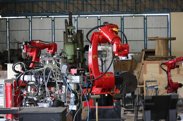 Robotics arm in the metal factory plant  its performing routine servicing of the welding robotics units equipment