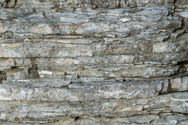 Rock the background of the layers of ancient sedimentsLayered stone