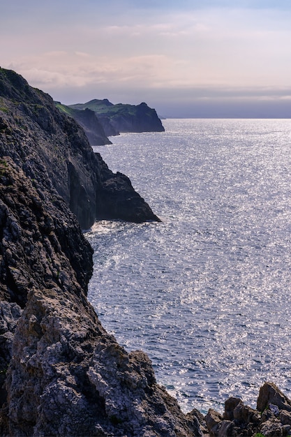 Rock cliffs jutting into the blue sea in the Cantabrian Sea