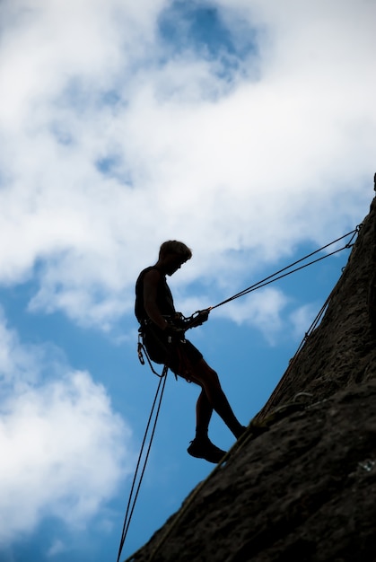 A rock climber ascends to the top