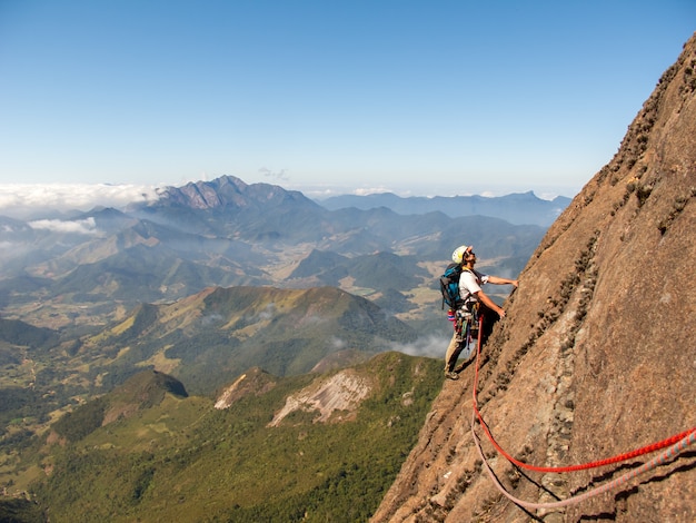 Rock climber climbing a sloping rock wall in Brazil