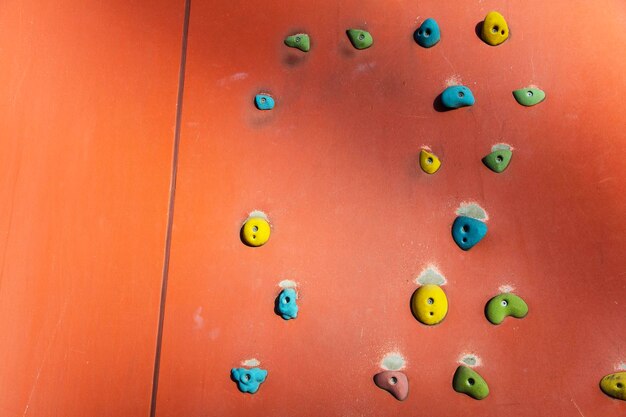 Rock climbing or Bouldering wall with colourful hand holds