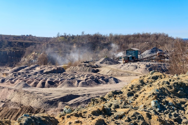 Rock crusher machine crushing machinery conveying crushed granite gravel stone in a granite quarry Processing plant for crushed stone and gravel Mining equipment