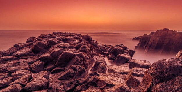 Foto formazione rocciosa sulla spiaggia contro il cielo durante il tramonto