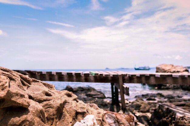 Rock formation on beach against sky