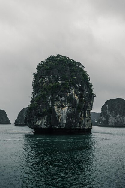 Rock formation in sea against sky