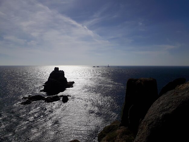 Rock formation on sea against sky