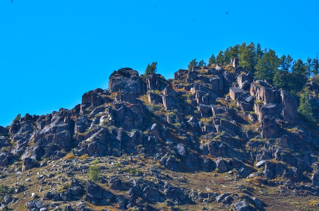 Rock formations against clear blue sky