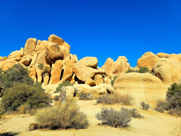 Rock formations against clear blue sky