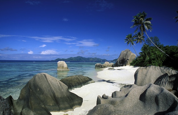 rock formations on beach against cloudy sky