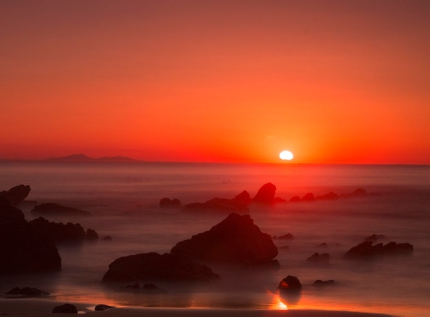 rock formations in the beach at sunset light