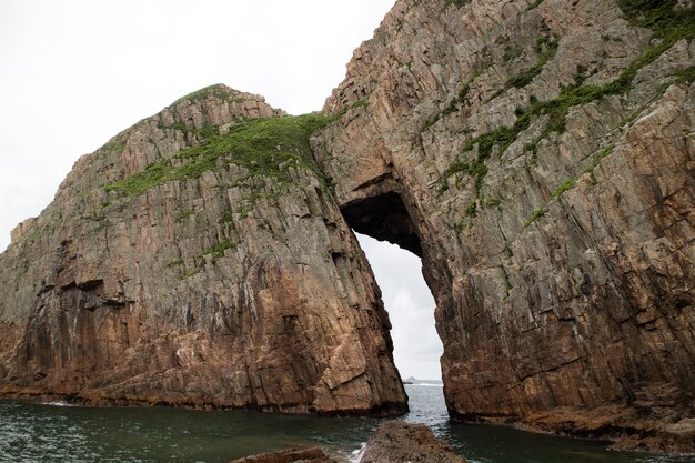 Rock formations by sea against sky