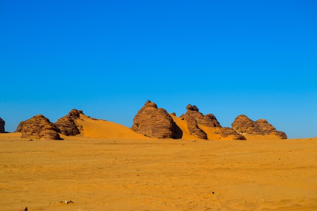 Rock formations in desert against blue sky