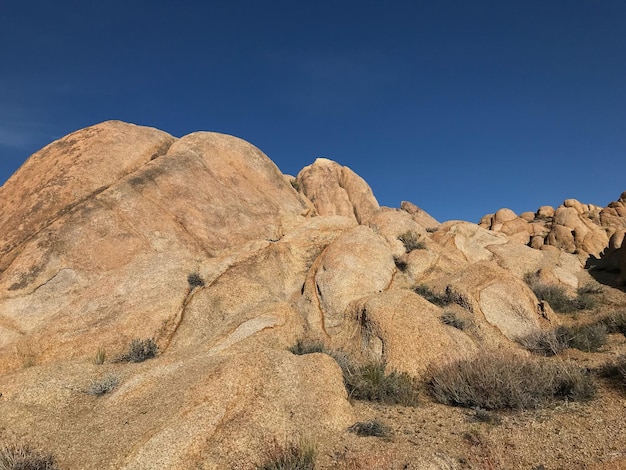 Rock formations in desert against blue sky