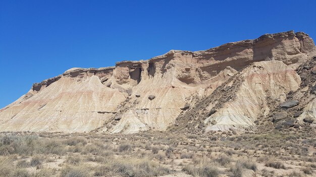 Rock formations in desert against clear blue sky