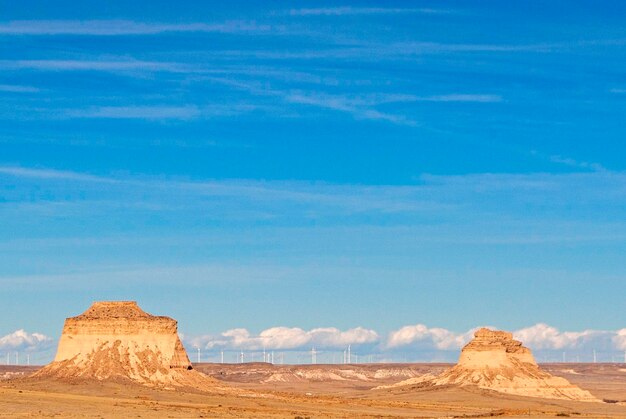 Rock formations on landscape against blue sky