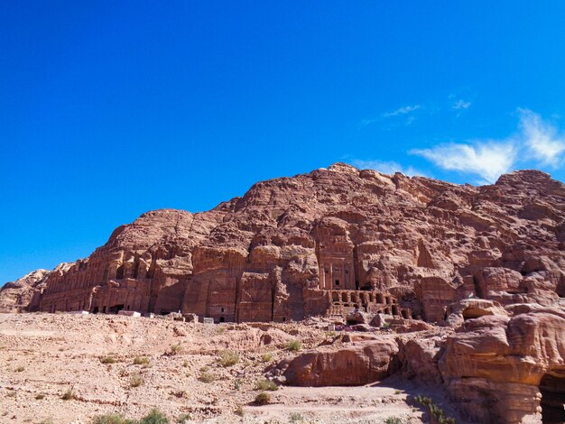 Rock formations on mountain against blue sky