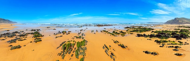 Rock formations on sandy beach Algarve Costa Vicentina Portugal Three shots stitch highresolution panorama