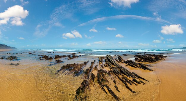 Rock formations on sandy beach Portugal