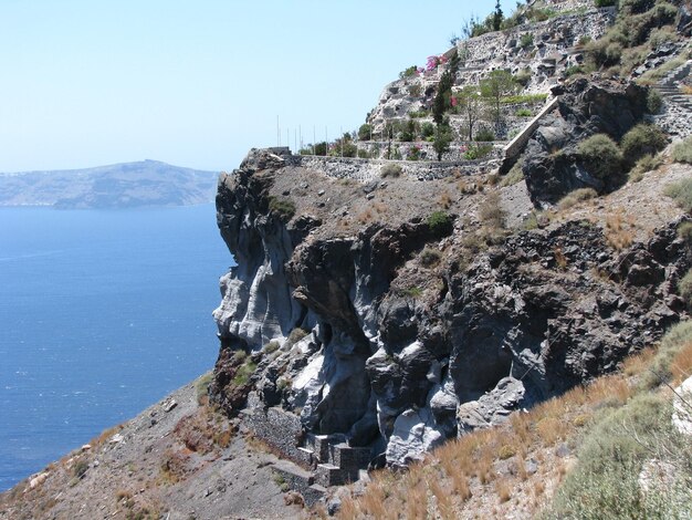 Rock formations in sea against sky