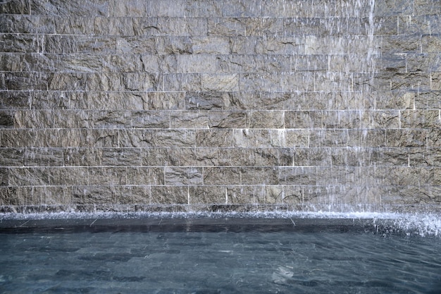 Rock gray fountain flowing in pond