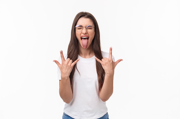 Rock-n-roll baby. Portrait of enthusiastic good-looking young girl having fun on awesome concert