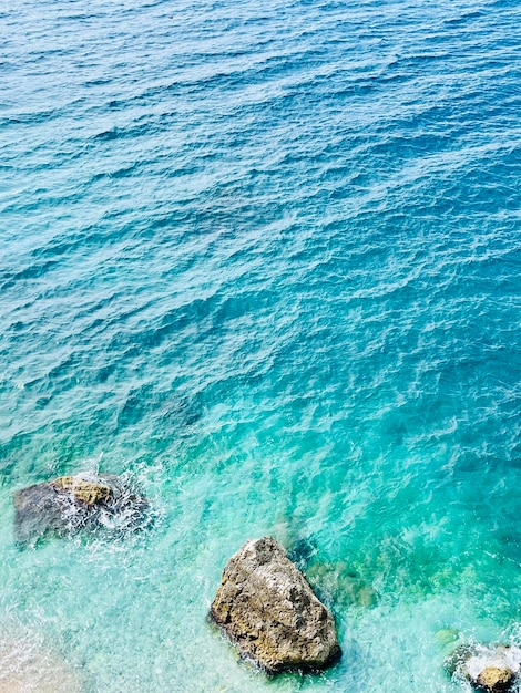 a rock in the ocean with a view of the ocean and the ocean