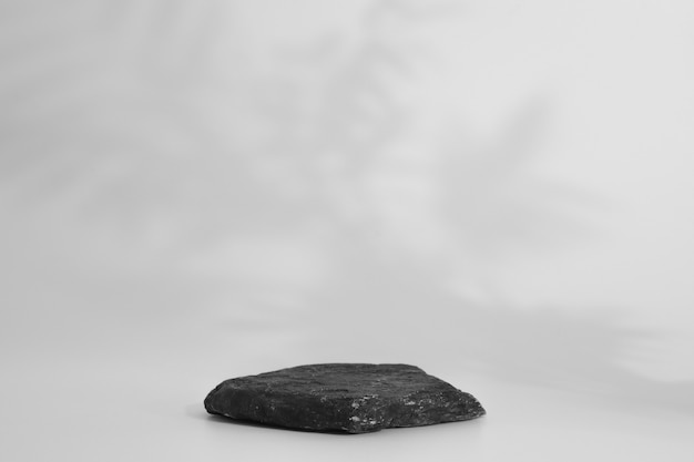 Rock podium on the white background. Stone podest for product, cosmetic presentation. Creative mock up. Pedestal or platform for beauty products.