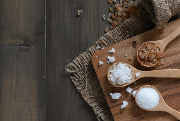 Rock sugar and granulated sugar on wood spoon 