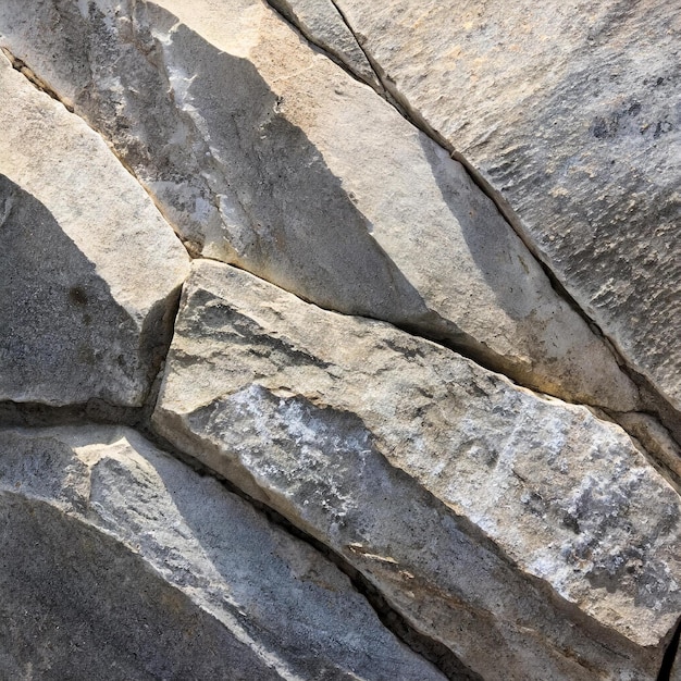 a rock with a white mark on it and a shadow on it