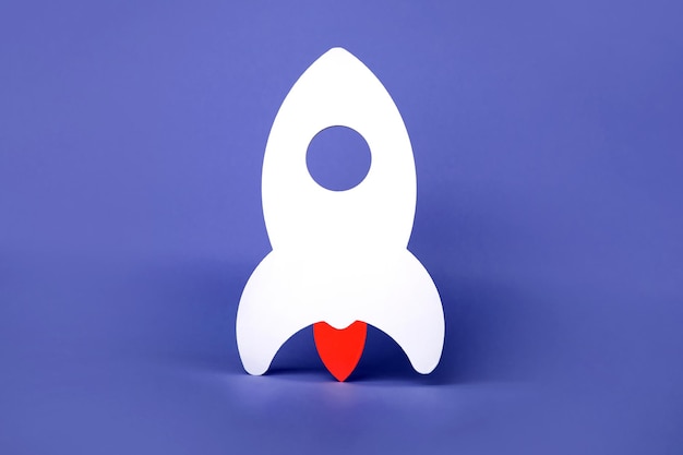 Rocket on a purple background, a symbol of a new startup