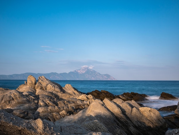 Rocks on beach against blue sky