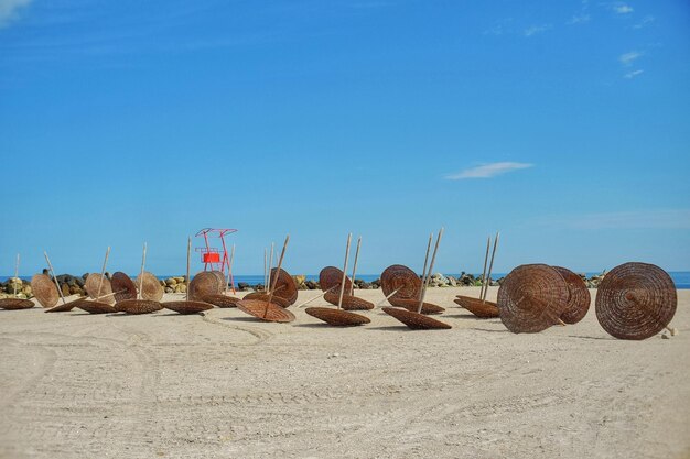 Rocks on beach against blue sky