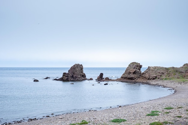 Rocks on beach against clear sky