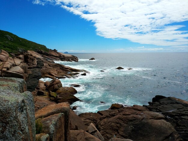 Rocks on beach against sky