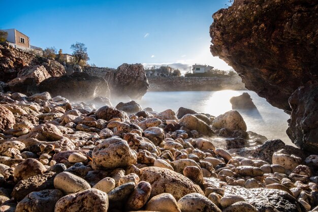 Rocks on beach against sky