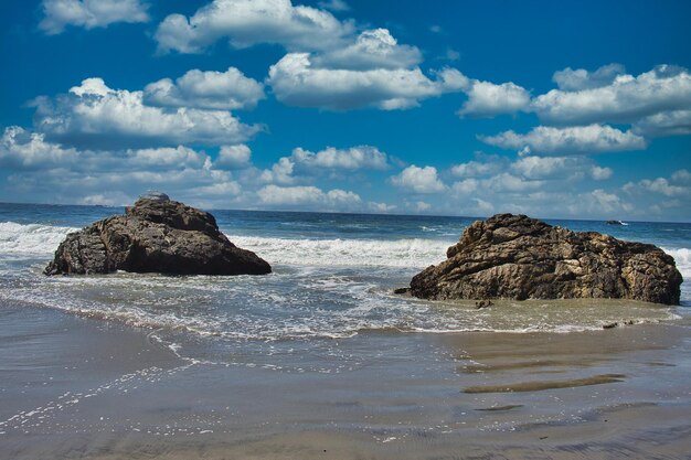 Rocks on beach against sky