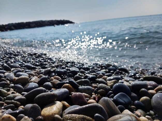 Rocks on beach against sky