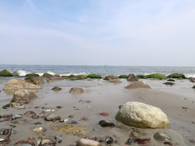 Rocks on beach against sky