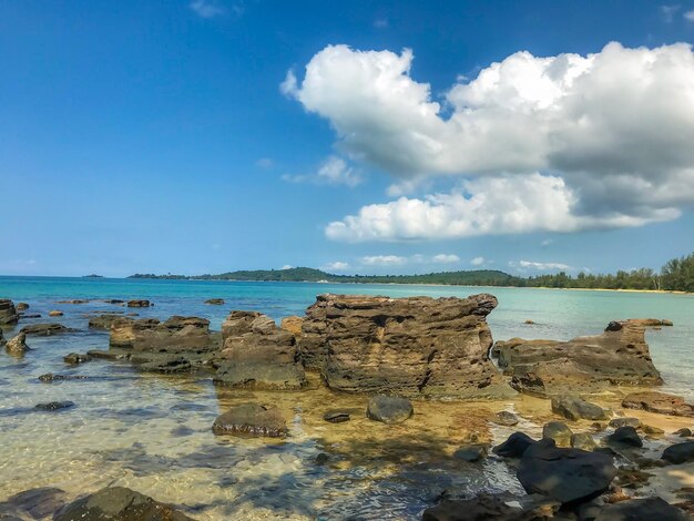 Rocks on beach against sky