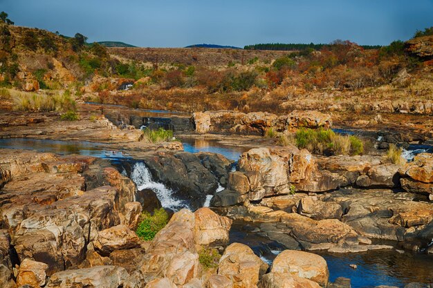 Photo rocks by river against sky