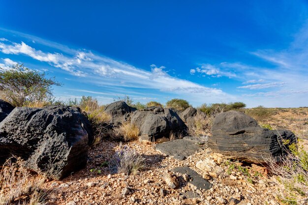Rocks on landscape against blue sky